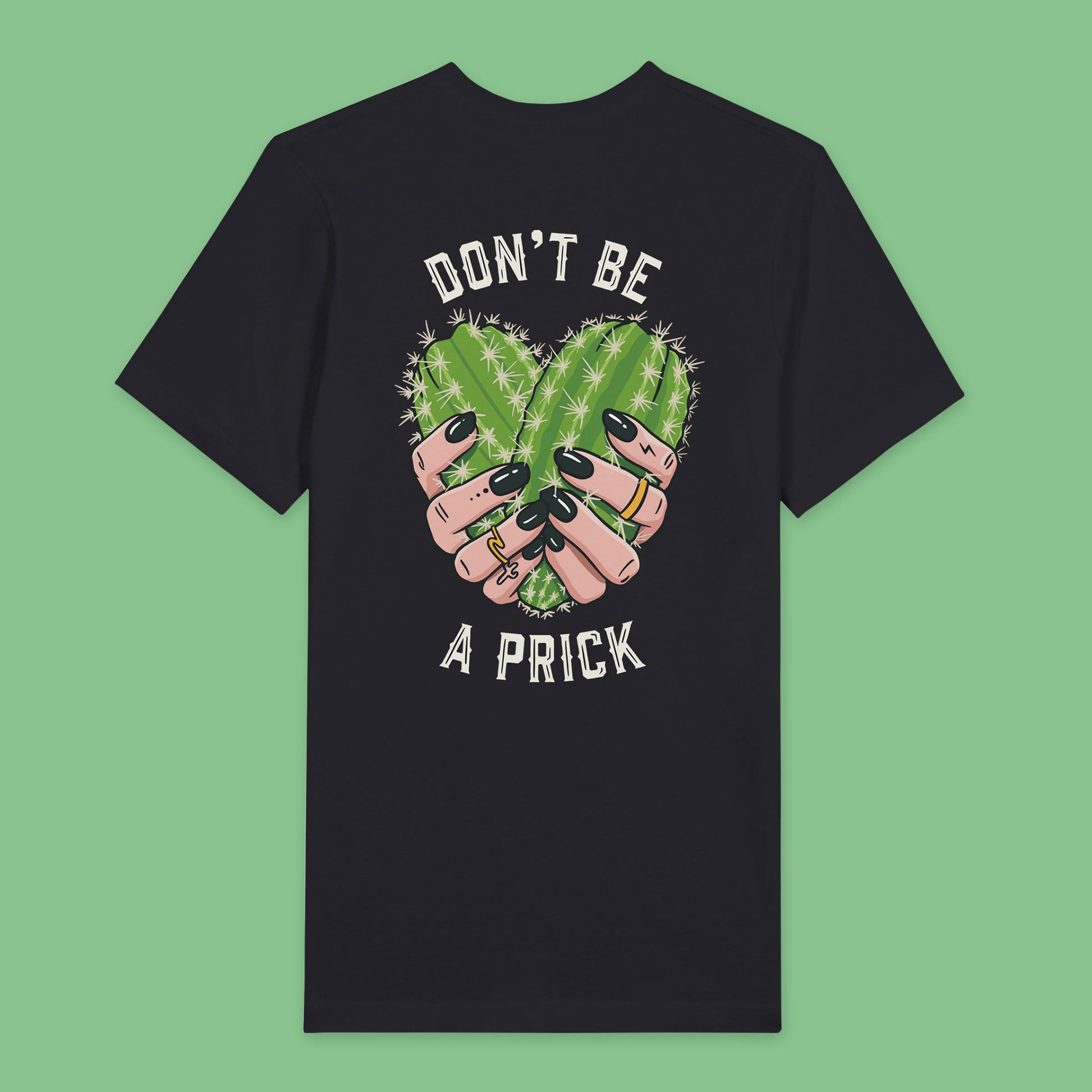 Back view of Black t-shirt featuring a design of two cactuses arranged in the shape of a heart with text around it reading don’t be a prick.