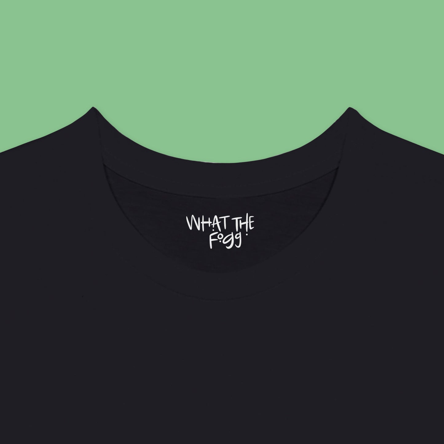 Close-up of the inside label on a black T-shirt, showing the text 'What the Fogg.