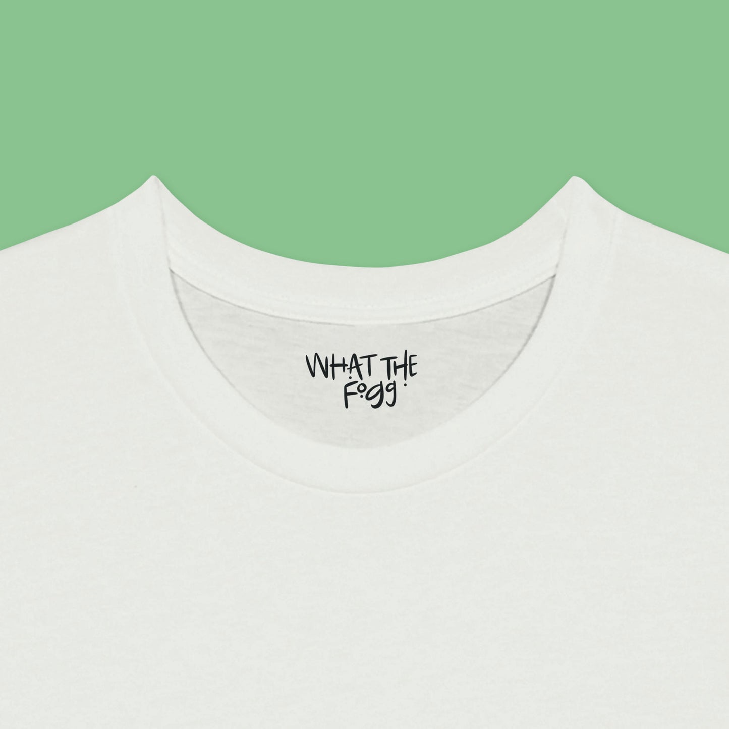 Close-up of the inside label on a white T-shirt, showing the text 'What the Fogg.
