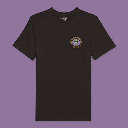 Black t-shirt featuring a playful twist on the traditional Neighbourhood Watch poster. The front of the shirt displays a circular badge with a design of aliens instead of people. The badge is surrounded by the text 'Neighbourhood Watch' in a bold, eye-catching font.
