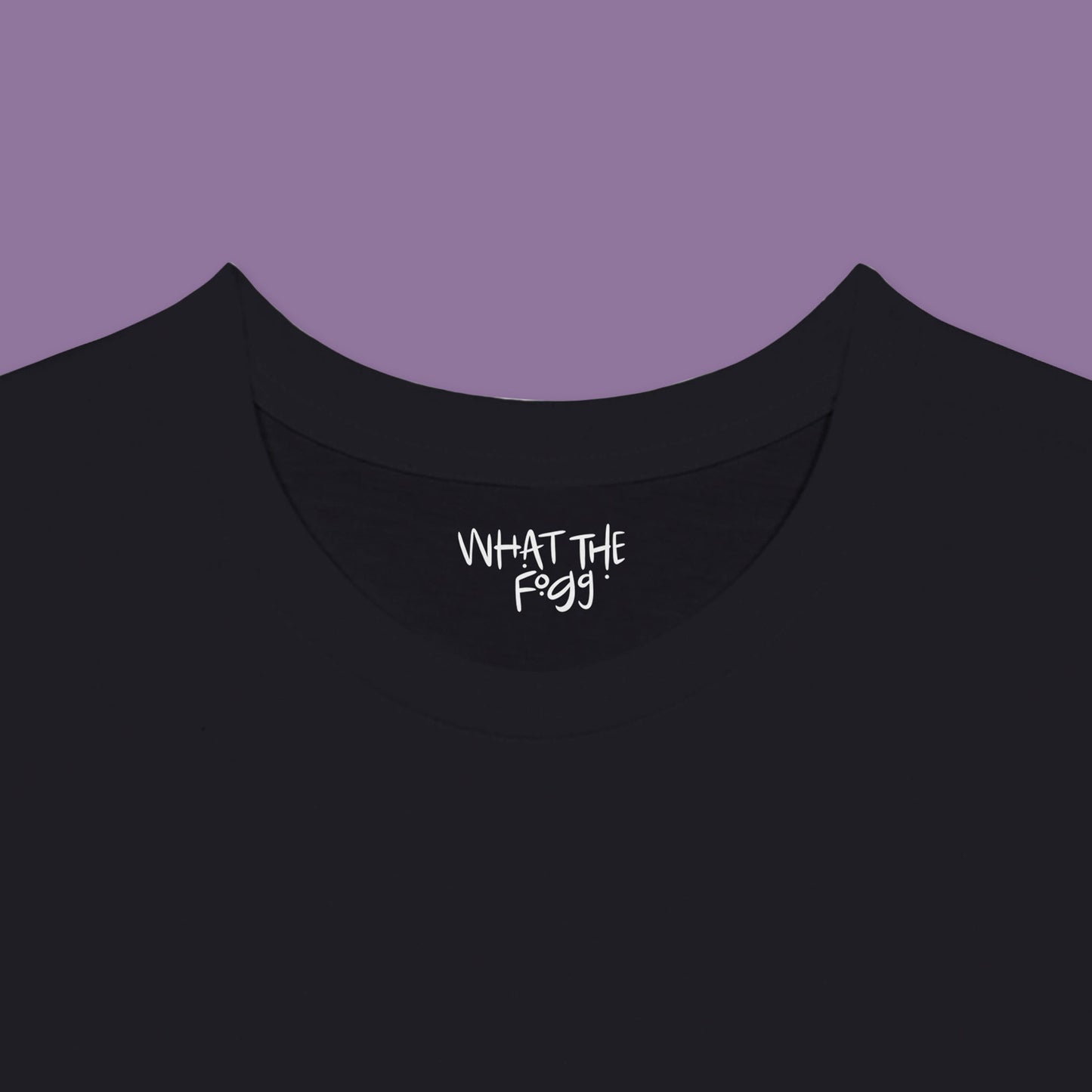 Close-up of the inside label on a black T-shirt, showing the text 'What the Fogg.
