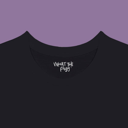 Close-up of the inside label on a black T-shirt, showing the text 'What the Fogg.