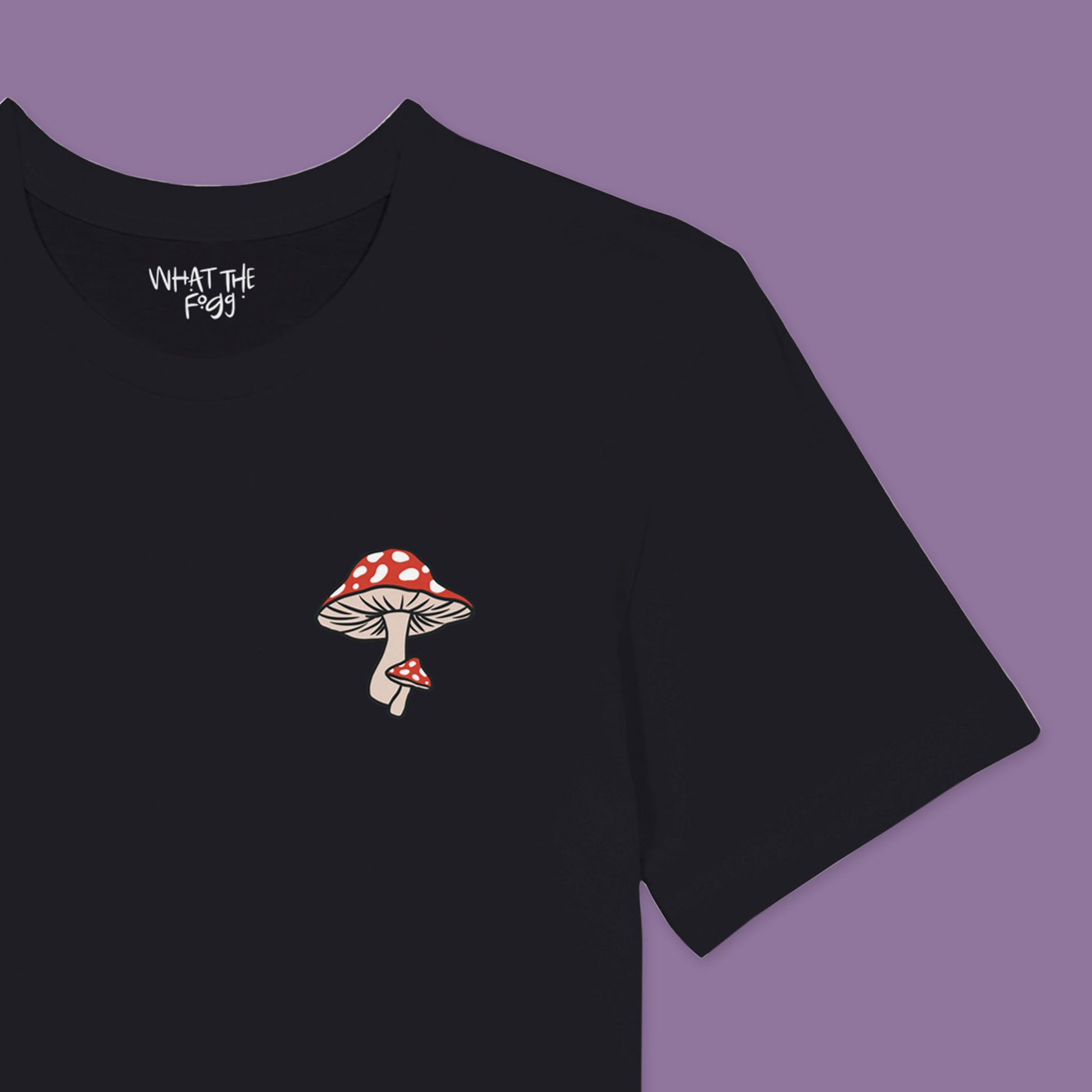 Close up of White T-shirt with red mushroom printed in front left chest area.