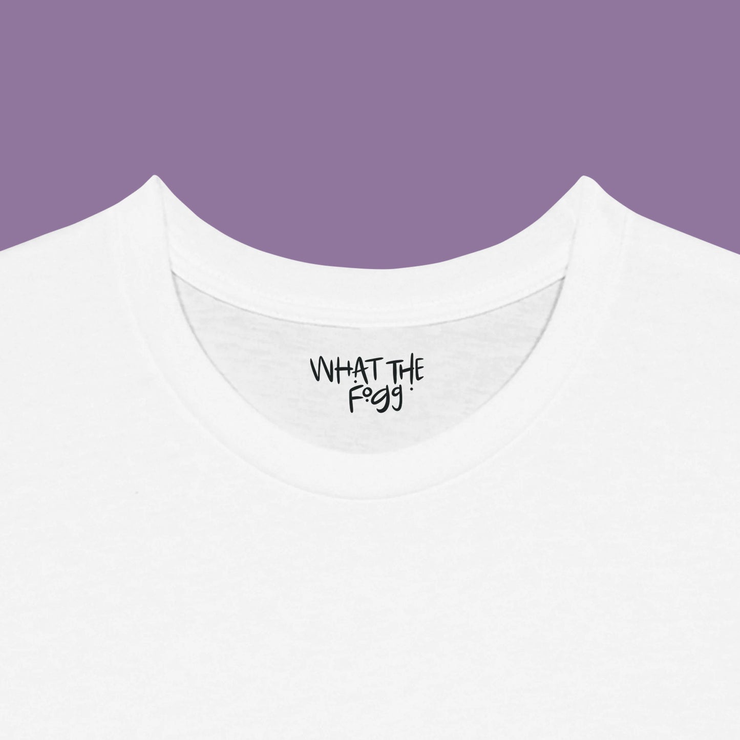 Close-up of the inside label on a white T-shirt, showing the text 'What the Fogg.