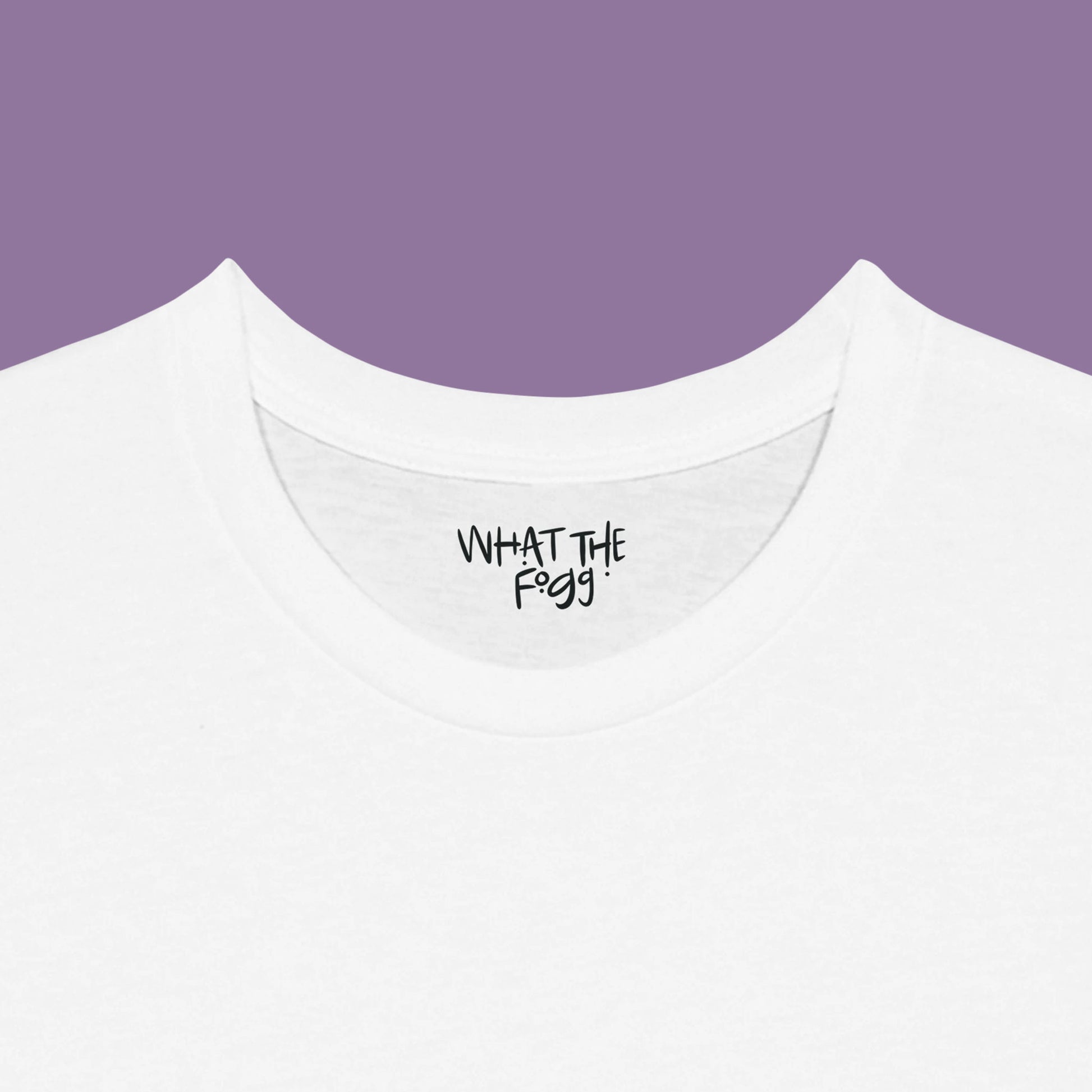 Close-up of the inside label on a white T-shirt, showing the text 'What the Fogg.