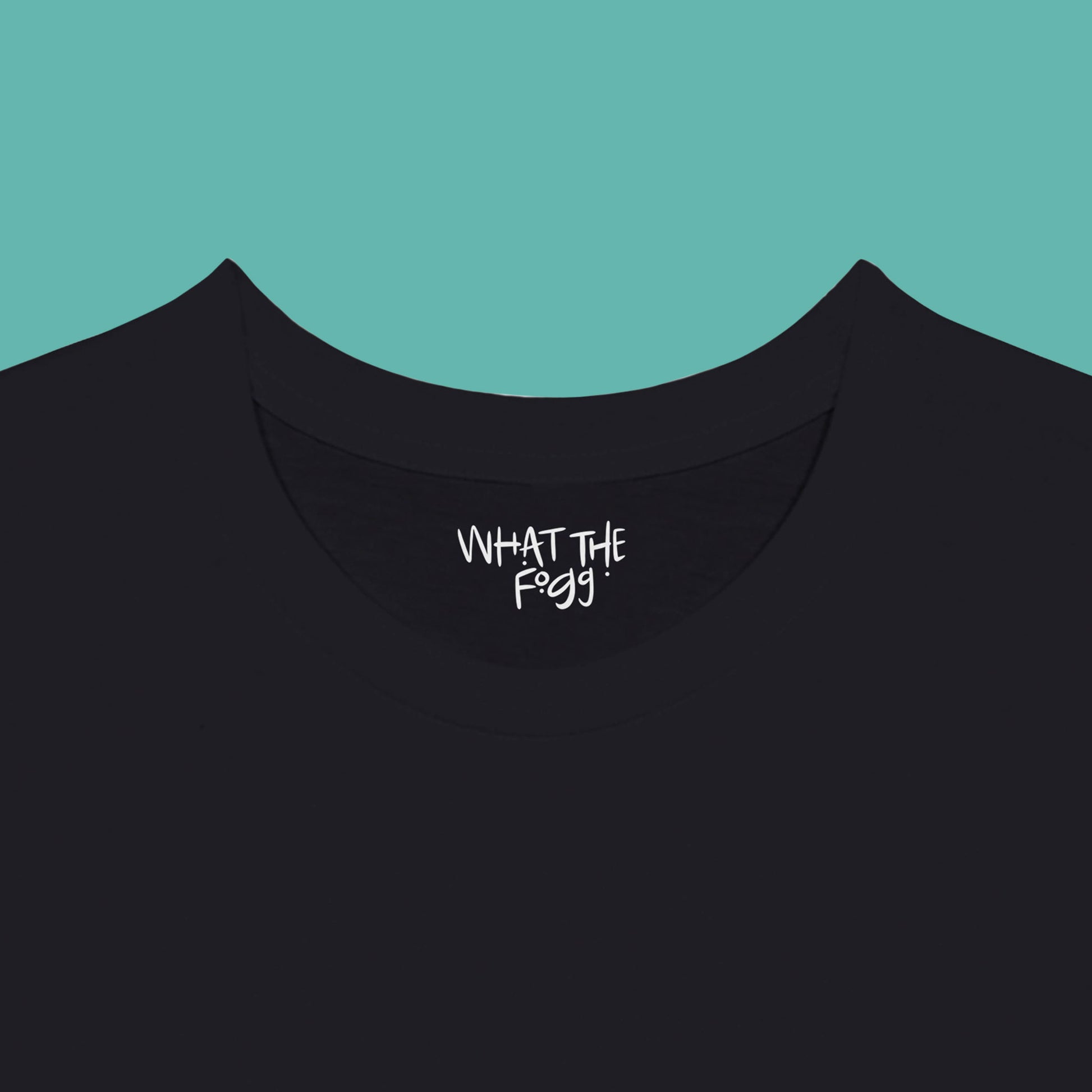 Close-up of the inside label on a black T-shirt, showing the text 'What the Fogg.