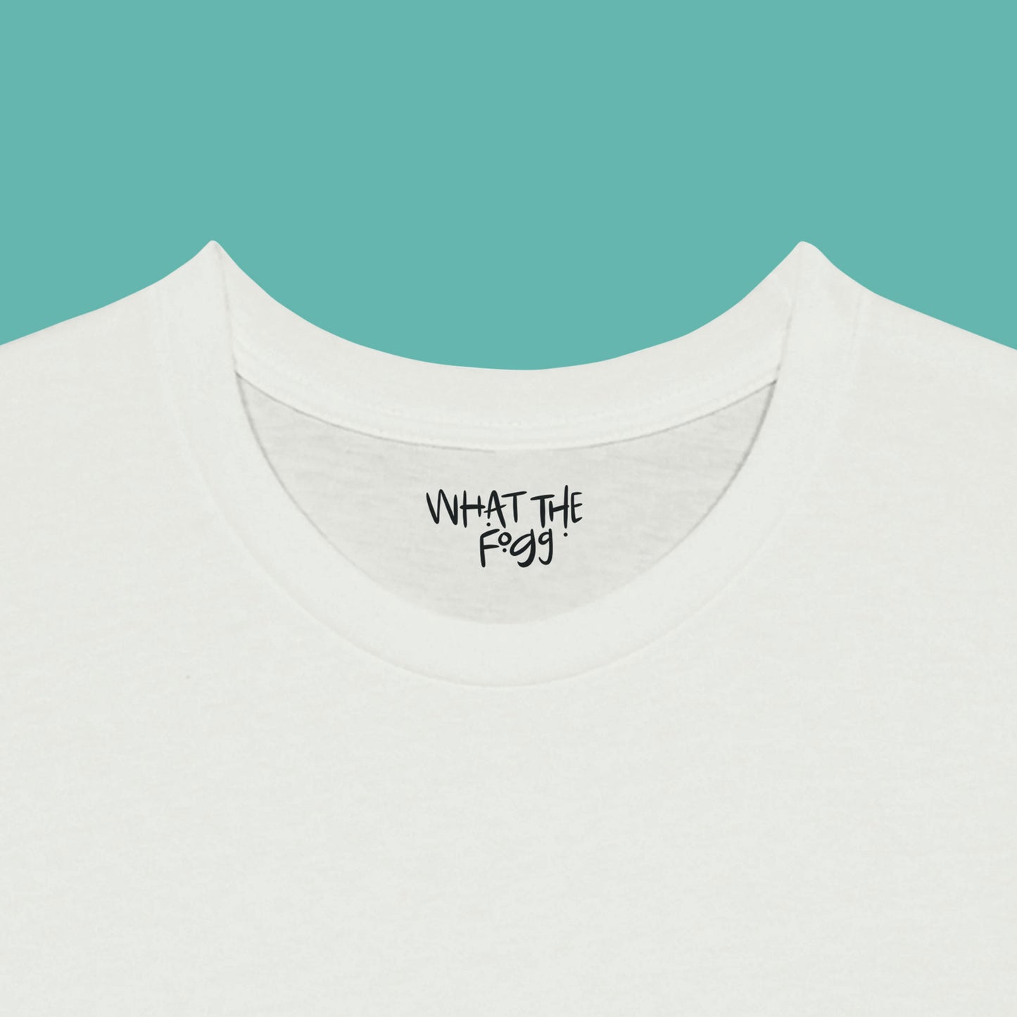 Close-up of the inside label on a white T-shirt, showing the text 'What the Fogg.