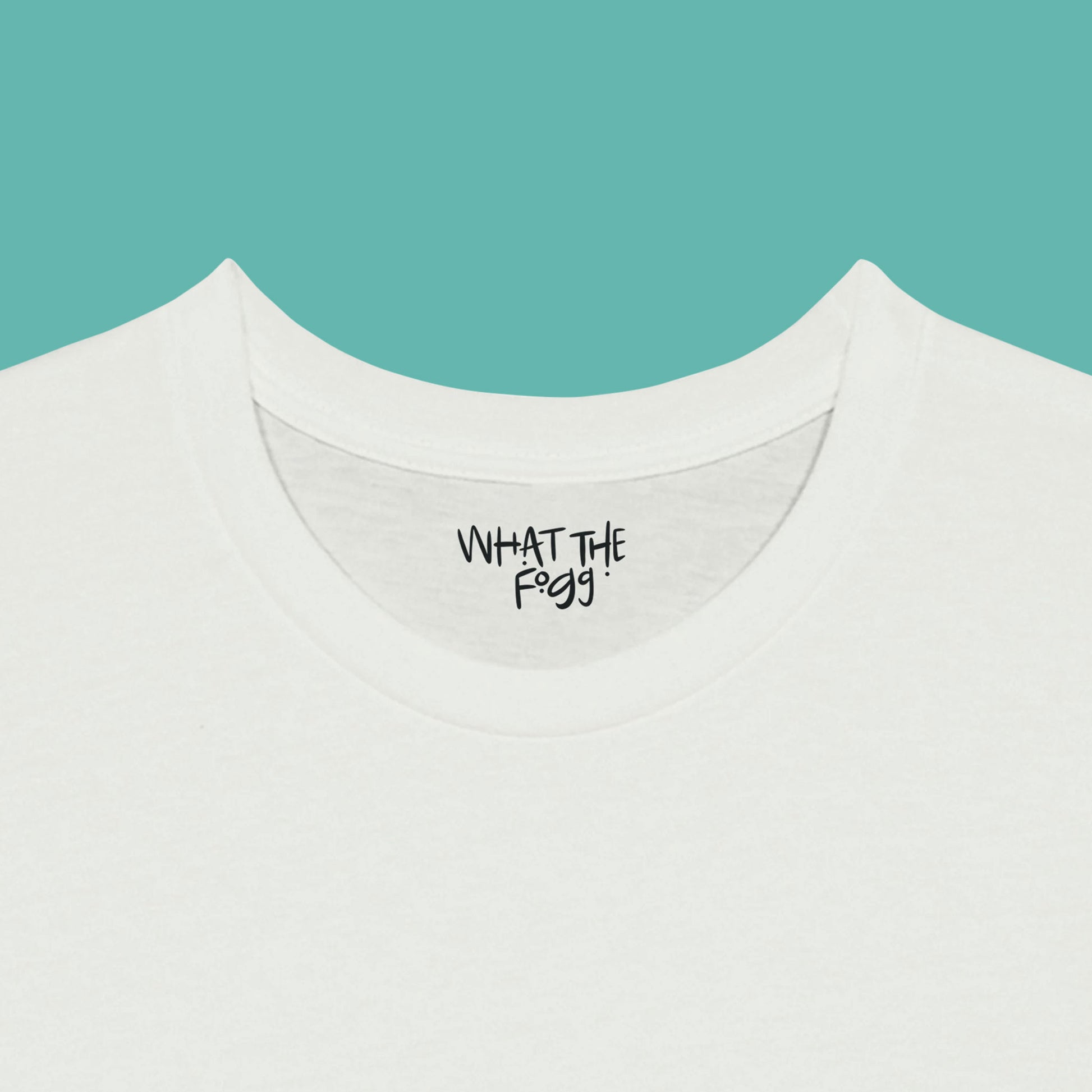 Close-up of the inside label on a white T-shirt, showing the text 'What the Fogg.