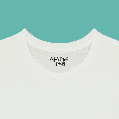 Close-up of the inside label on a white T-shirt, showing the text 'What the Fogg.
