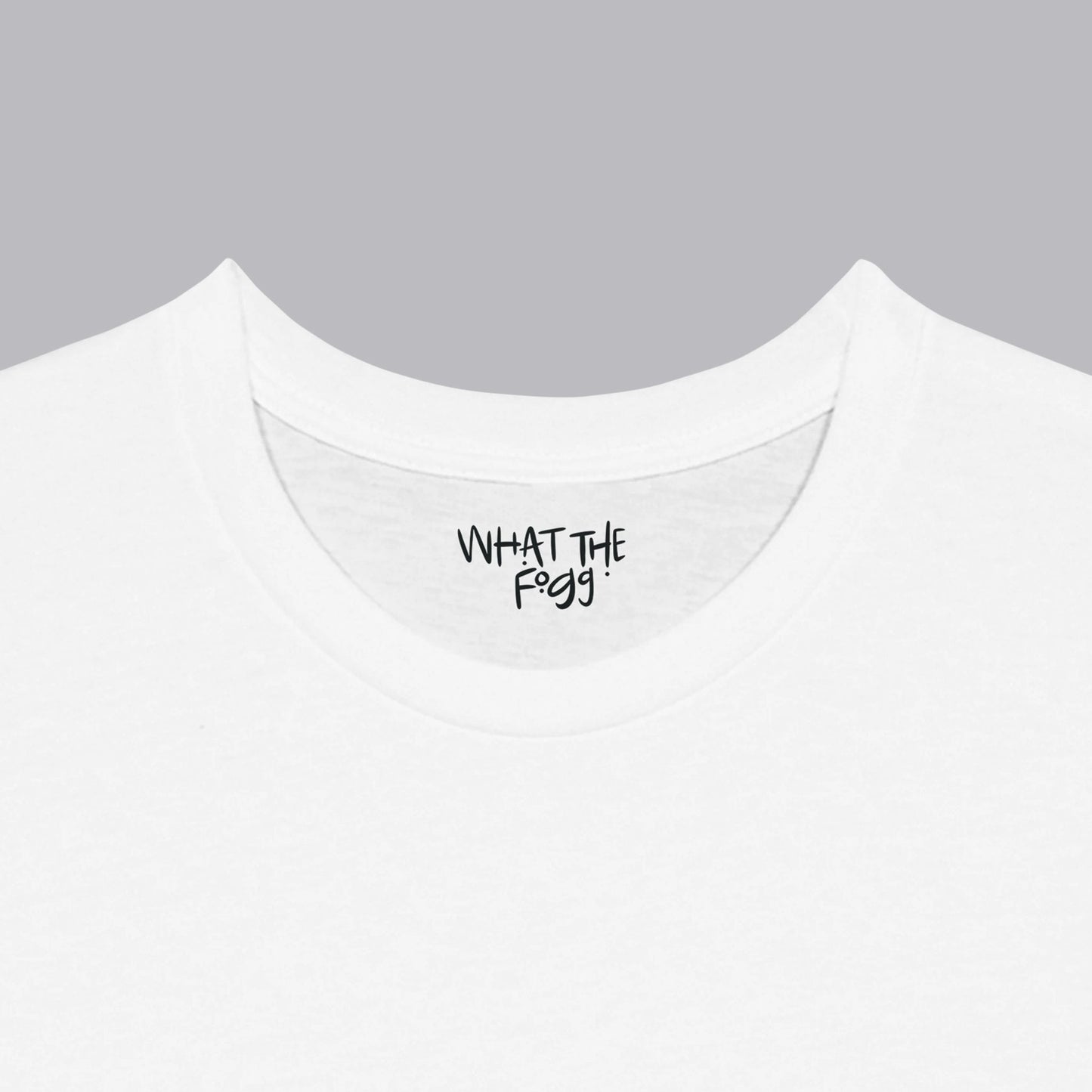 Close-up of the inside label on a white T-shirt, showing the text 'What the Fogg.