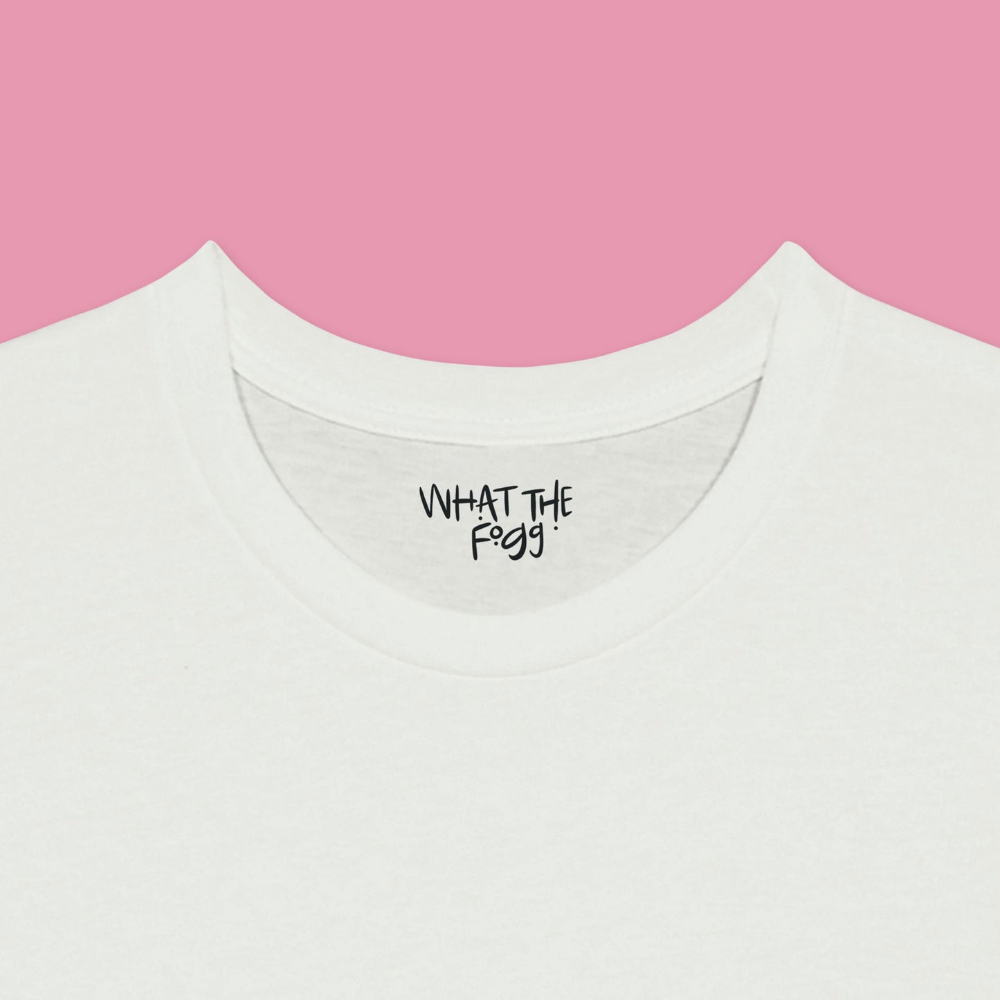 Close-up of the inside label on a white T-shirt, showing the text 'What the Fogg.