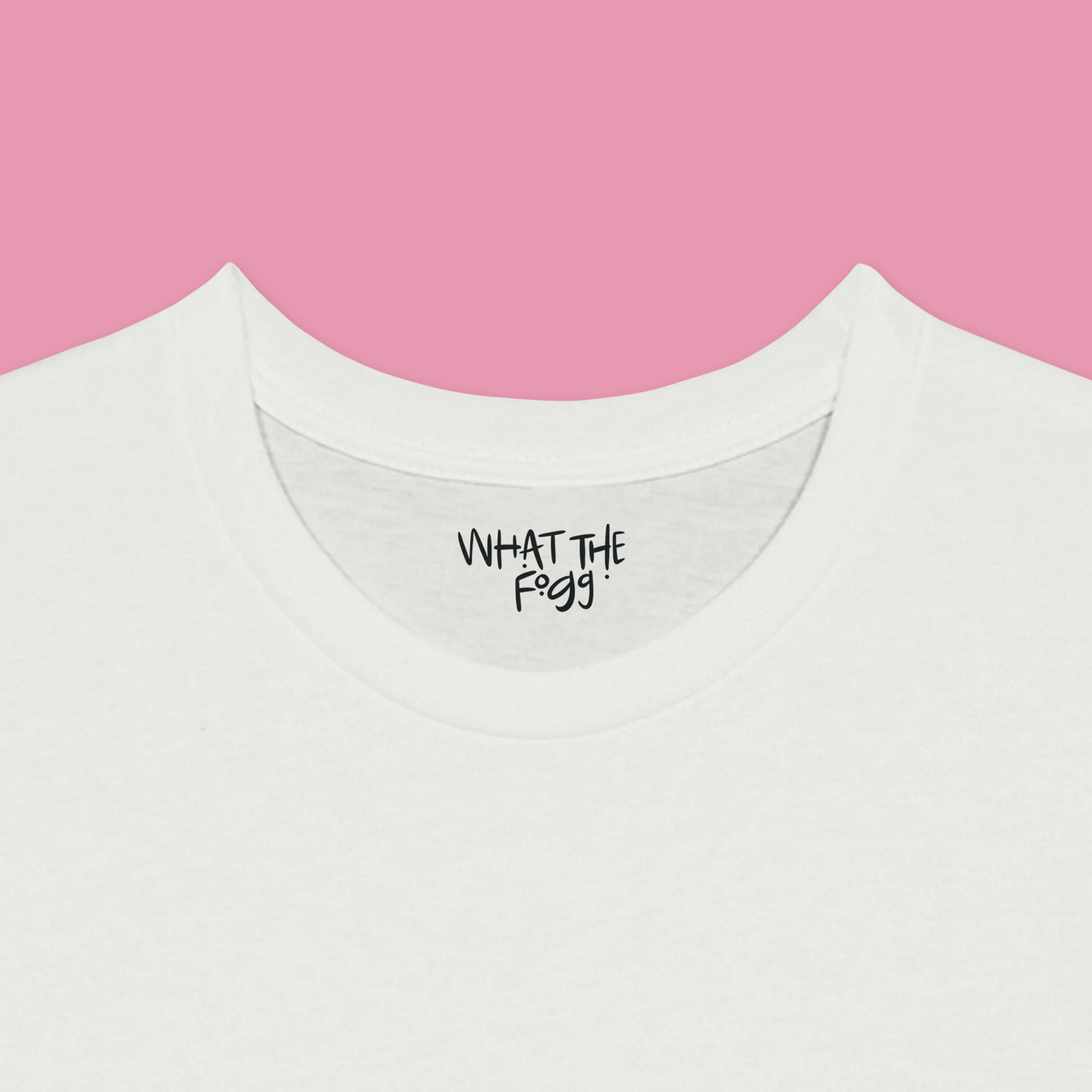 Close-up of the inside label on a white T-shirt, showing the text 'What the Fogg.
