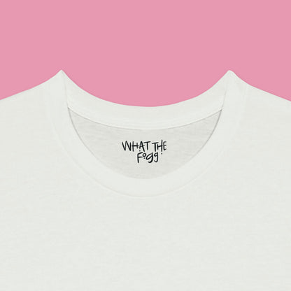 Close-up of the inside label on a white T-shirt, showing the text 'What the Fogg.
