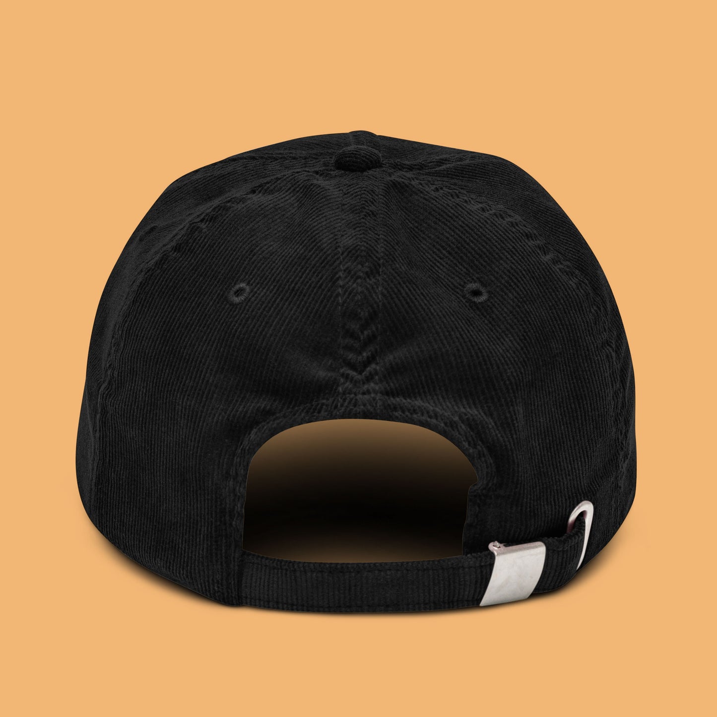 Back-angle view of a black corduroy hat with 'Weird Times' printed in white on the front.