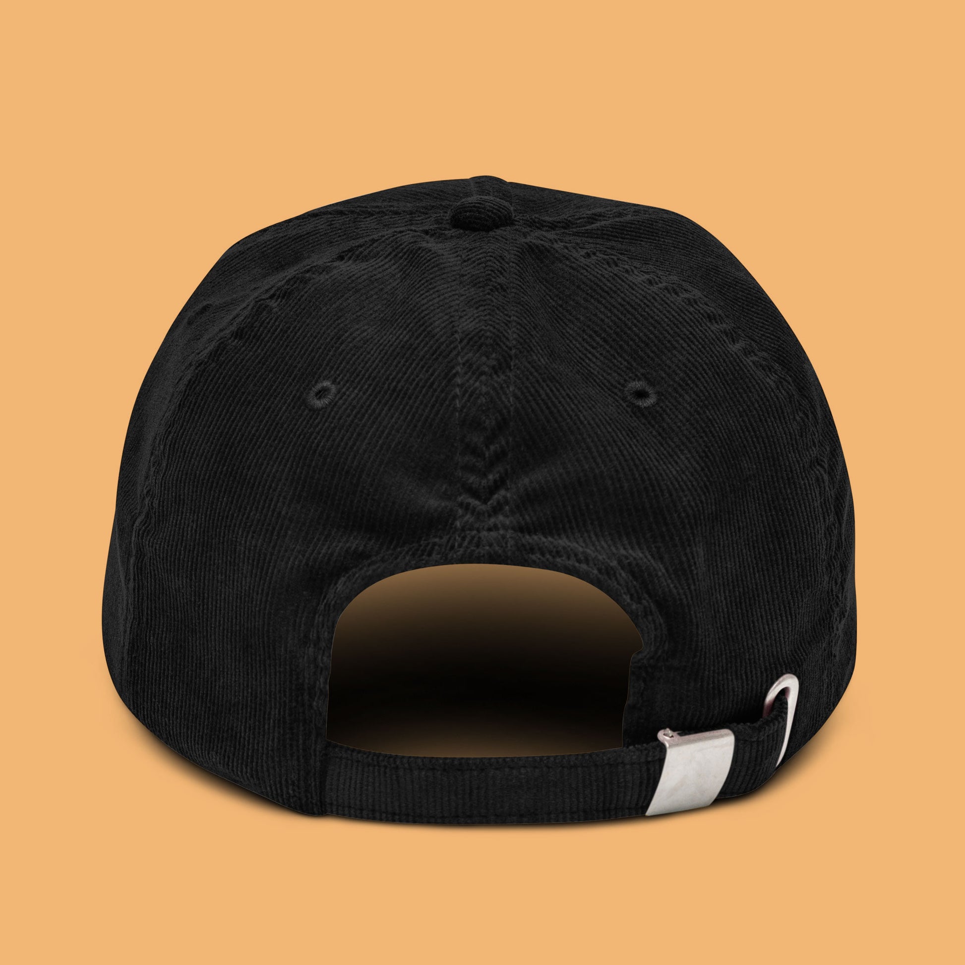 Back-angle view of a black corduroy hat with 'Weird Times' printed in white on the front.
